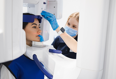 Dental patient getting a CT cone beam scan of her mouth and jaws