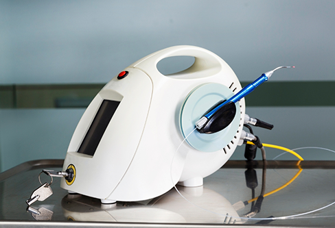 Small white device with a screen attached to a dental laser pen