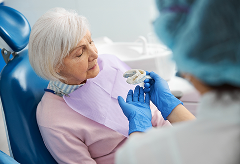 Senior woman getting dental impressions taken for dentures