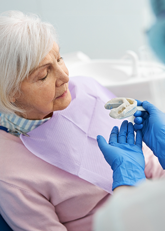 Senior woman getting dental impressions taken for dentures