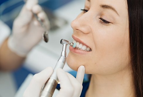 Woman getting a teeth cleaning from her dental hygienist