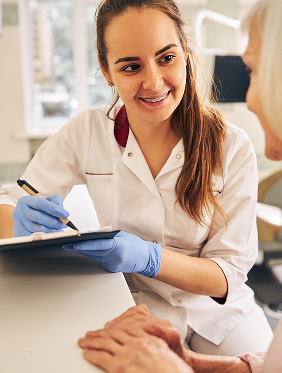 Stratford dental team member smiling as she listens to a patient