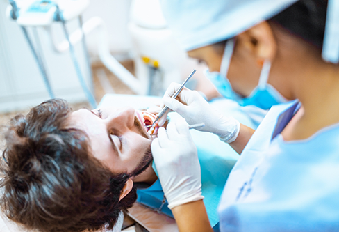 Man receiving root canal therapy from his Stratford dentist