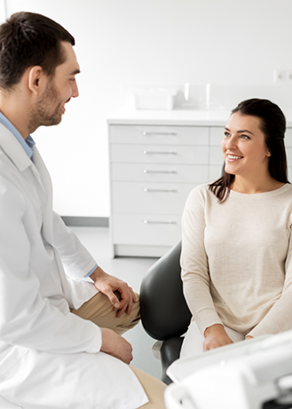 Woman in the dental chair listening to her dentist